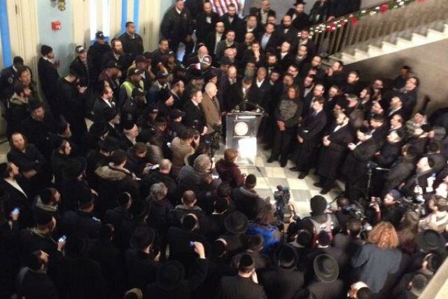 Hasidic community members as well as elected officials at Brooklyn Borough Hall yesterday